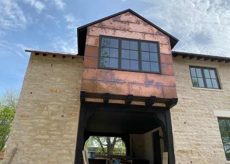 Copper metal panel facade on a stone building for Skylight Installation in Emmett